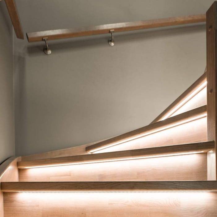 The design of staircase lighting must take into account confined spaces. Led strip at the bottom of the stairs.